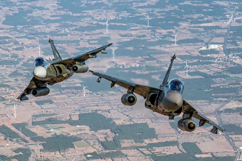 Two camouflaged Tejas of No. 45 Squadron in close formation over fields